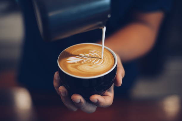 A man pouring coffee into a mug