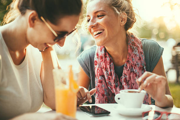 Two sisters enjoying drinks outside